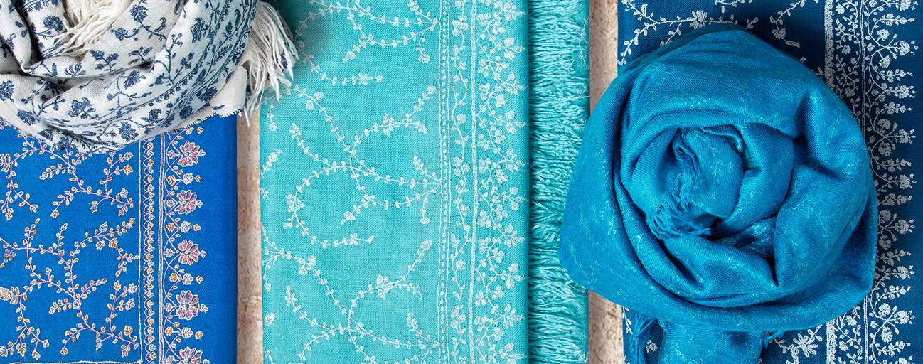 Pashmina shawls in shades of blue with hand embroidery all over.