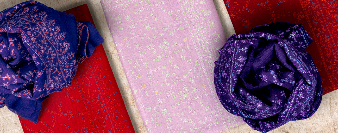 Pashmina shawls with all over embroidery in shades of pink, red and purple