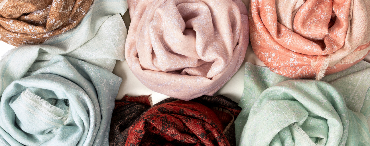 A selection of reversible and embroidered pashmina shawls.